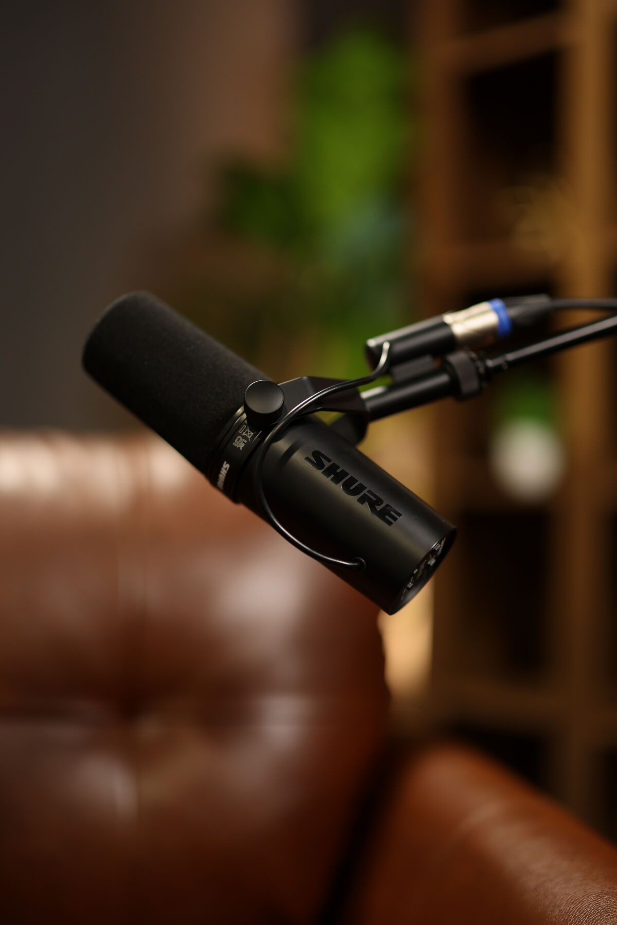 Shure microphone on a boom arm in the Now In Rhythm podcast studio