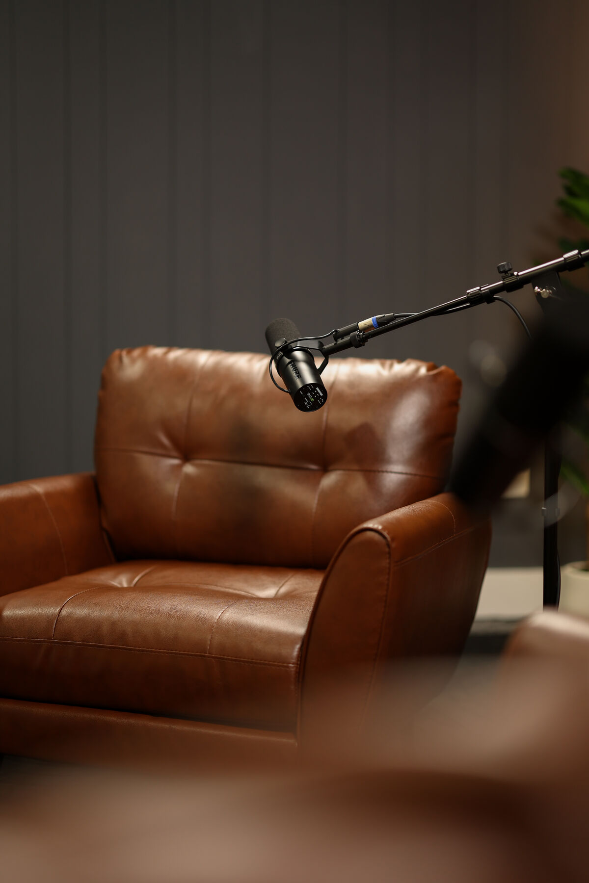 Leather guest chair and microphone in the Rhythm Collective podcast studio